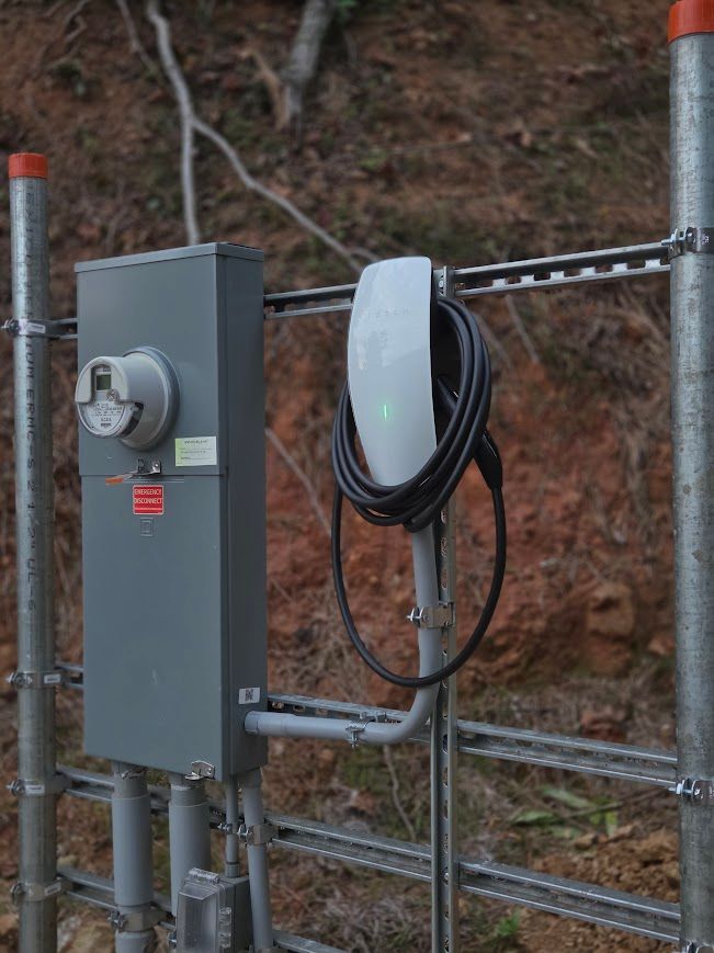 Tesla wall connector EV charger installed beside meter base in Sevierville, TN