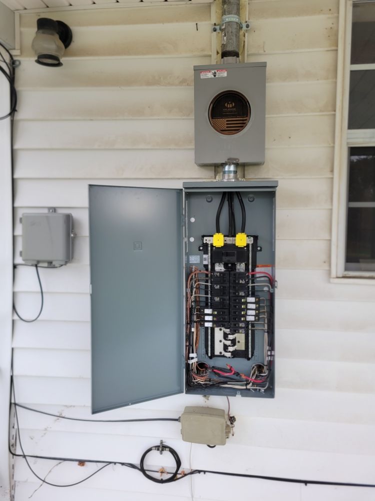 Exterior meter base and open subpanel with American flag wrap